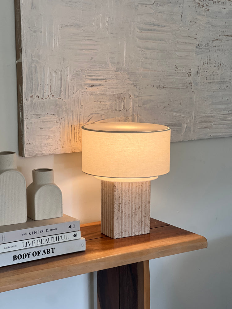 Wooden lamp with a light bulb on a textured wall background