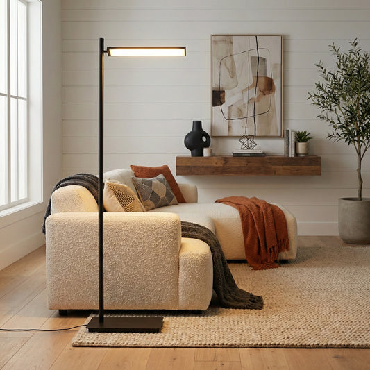 Modern living room with a beige sofa, floor lamp, and abstract art on the wall.