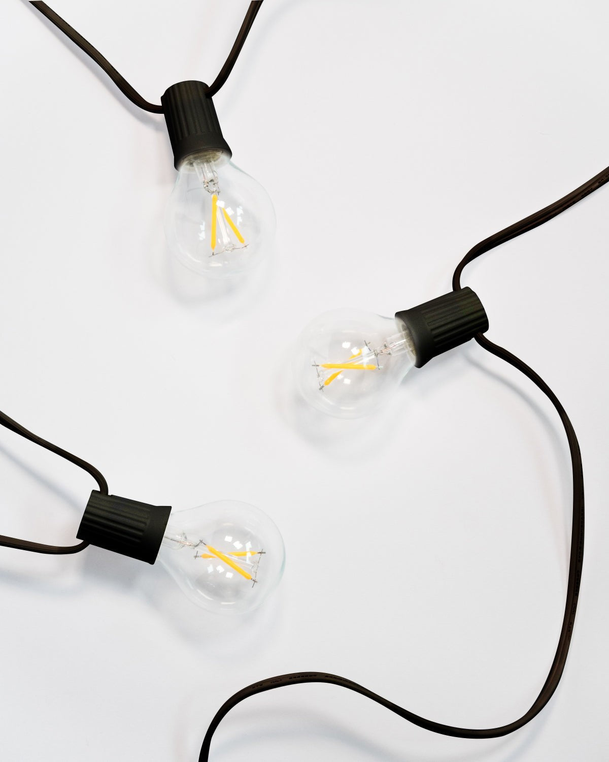 Brightech Ambience Globe LED string lights with black sockets and clear globe bulbs, lights off