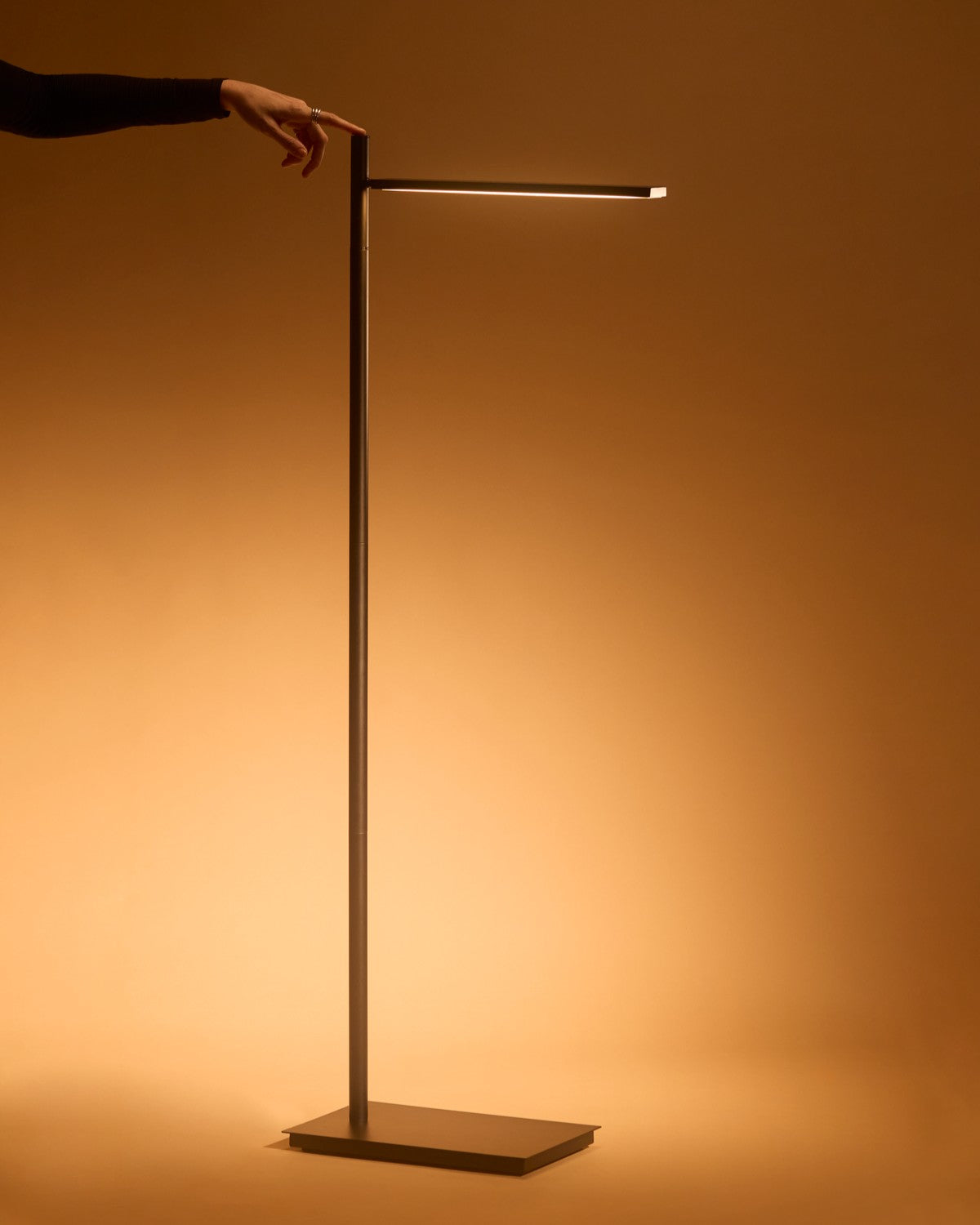 Brightech Linden floor lamp with a slim LED bar casting warm light down a wall